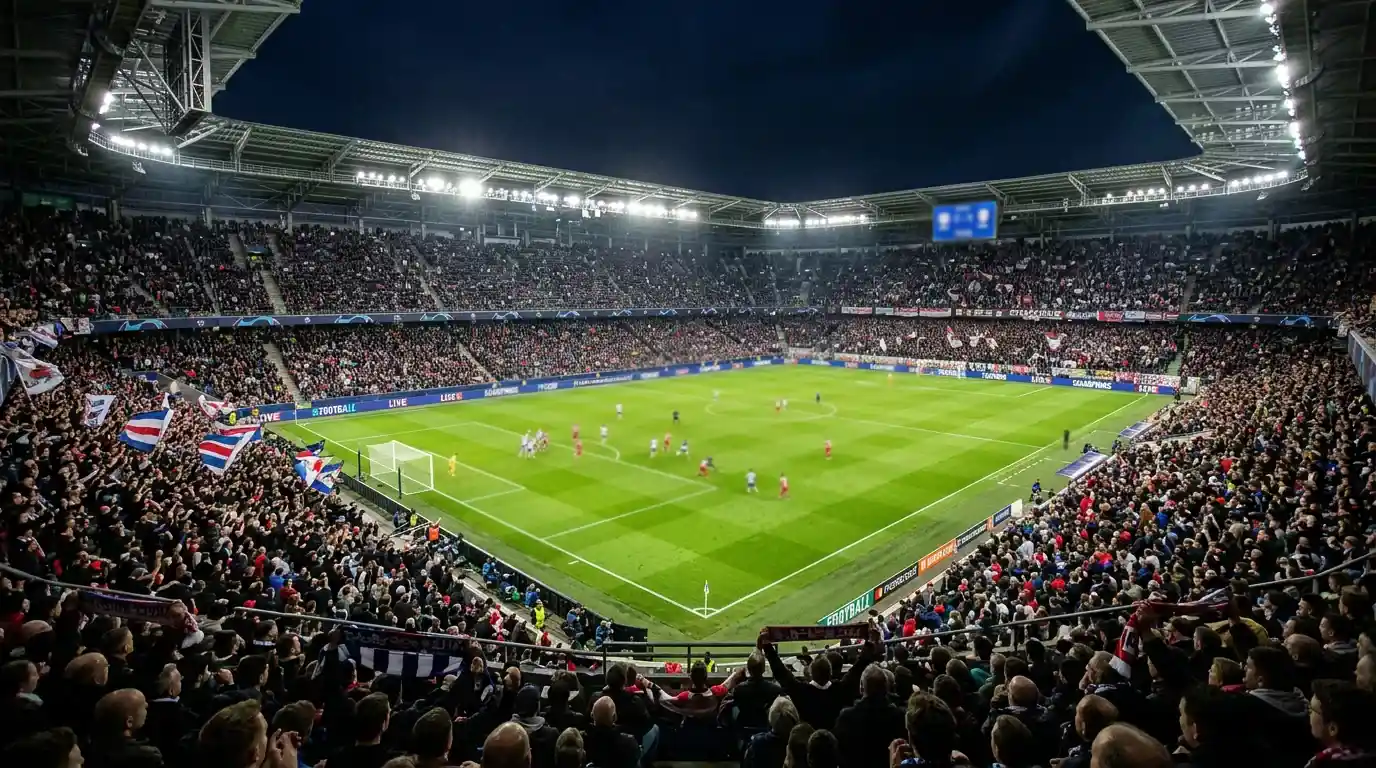 Estadio de fútbol iluminado durante un partido de la fase de liga de la Champions League con el formato de 36 equipos